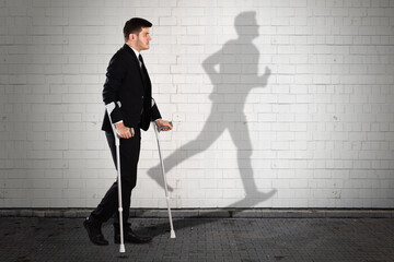 Shadow Of Man On Wall With Businessman Walking On Sidewalk