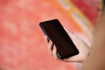 mobile phone over the shoulder outside on the go
