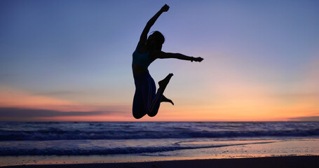 woman jumping on beach