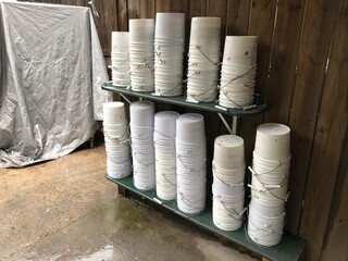 piles of empty white buckets