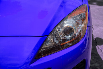 headlight of modern prestigious car closeup red car