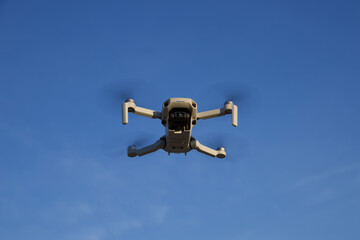 A small drone hovering in the air.