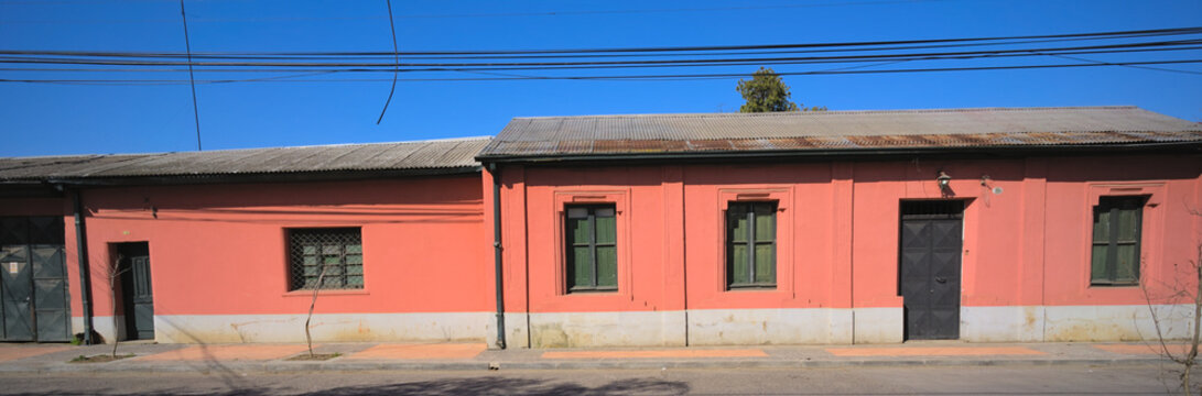 Facade Of A One-floor Traditional Adobe House In A Small South American Town Under Blue Sky (Talca, Maule, Chile) 