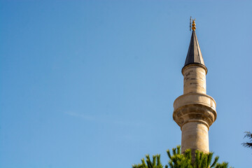 Minaret of a mosque in view. Silhouettes of Mosque