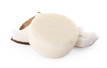 Solid shampoo bar and coconut pieces on white background. Hair care