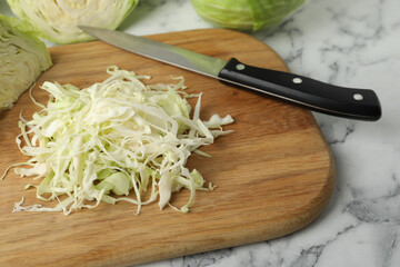 Chopped ripe cabbage on white marble table, closeup