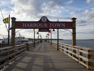 Beautiful view of the Harbor Town Pier against a blue cloudy sky in Hilton Head, South Carolina