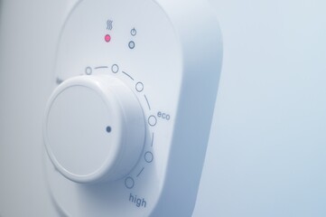 Temperature controller of the electric heater. Thermostat of a modern water heater this the eco mode of operation. Wheel of the temperature controller. Selective focus