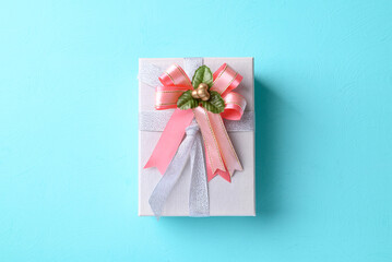 Silver gift box with pink ribbon on light blue color background, Present for giving in special day and holiday