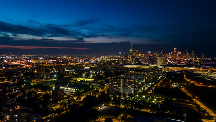 Fototapeta premium establishing aerial drone night time view of the Chicago skyline metropolis. the cityscape has beautiful architecture that tourist can sightsee.