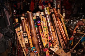Set of Andean flutes (flauta quena) from South America on a stall in a local craft market in Peru, Cusco. Traditional Andean wind instruments.