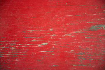 close up of old red painted board with flaking weathered paint and exposed wood grain - Powered by Adobe