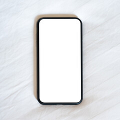 Close up smartphone with an empty white screen on the fabric texture bed in the bedroom.