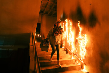 Brave Fireman Descends Stairs of a Burning Building and Holds Saved Girl in His Arms. Open fire and...