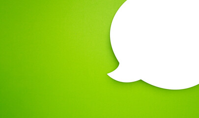 A blank white speech bubble part over a light green background