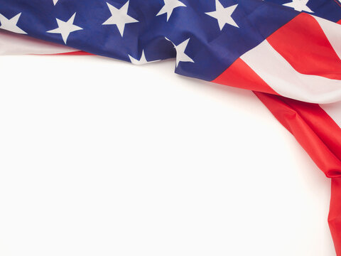 Top view of the American flag on a white background with copy space for text
