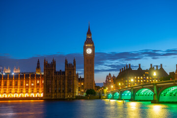 Fototapeta na wymiar Big Ben, Palace of Westminster and Westminster Bridge at sunset blue hour at night in London, England, UK. Big Ben and Palace is World Heritage Site since 1970. 