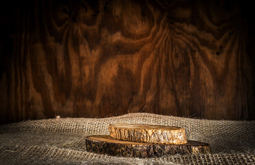 Wooden background with logs and sack to place products