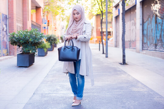 Hijabi girl looking at her watch
