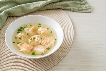 shrimp dumpling soup in white bowl