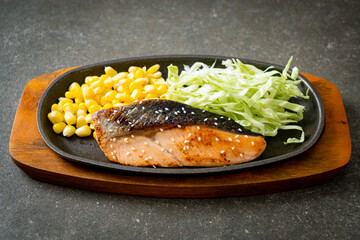 grilled salmon fillet steak on hot plate