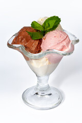 Ice cream of rum and chocolate in a metal spoon over plastic box.