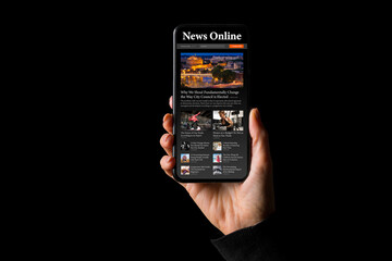 Person holding phone in hand with sample news website on the screen