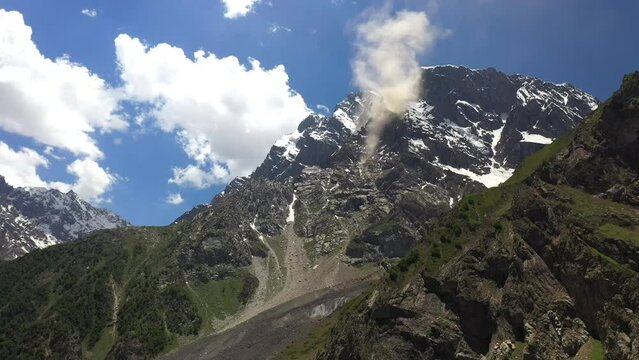 Drone shot of Nanga Parbat, Fairy Meadows Pakistan, looking up towards a mountain peak with clouds coming off ridge, cinematic aerial shot