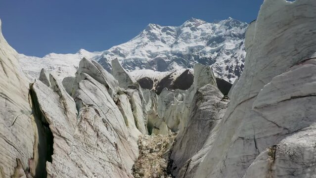 Aerial shot of flying through the glacier canyons with Nanga Parbat in the background, Fairy Meadows Pakistan, cinematic drone shot