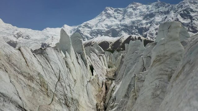 Drone shot of flying through the glacier canyons with Nanga Parbat in the background, Fairy Meadows Pakistan, cinematic aerial shot