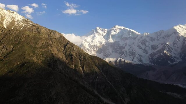 Aerial shot of over mountain cliffs towards Nanga Parbat, Fairy Meadows Pakistan, snow-capped mountains, cinematic drone shot
