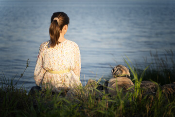 Portrait of a girl and her little dog, rear view