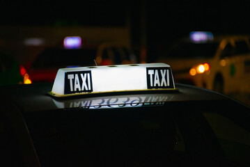 Taxi sign lit on dark background