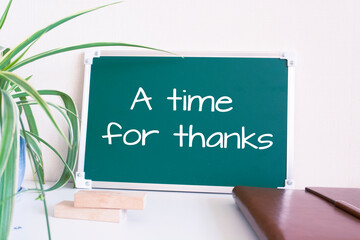 Text a time for thanks written on the green chalkboard