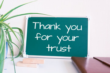 Text Thank you for your trust written on the green chalkboard