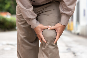 Old senior man hand holding knee joint pain, concept of osteoporosis, thin bone, osteoarthritis;...