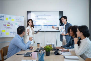 Group of Asian business people meeting to discuss and plan investment business and market analysis for business development There are data project plans for various analyzes and use a laptop computer.
