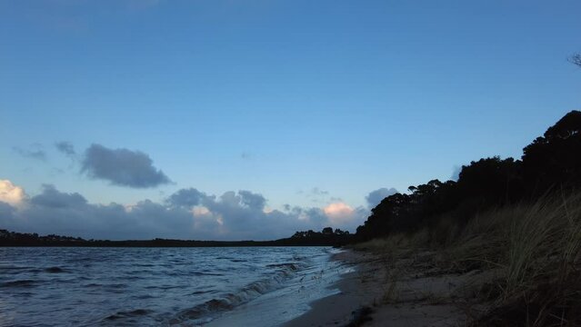 Man walking down a beach on a cold winters morning in Tasmania, Australia
