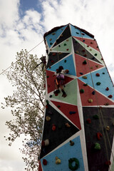 child girl climbing a climbing wall