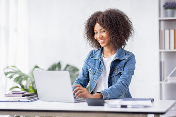 Creative young african american woman working on laptop in her studio,Doing accounting analysis...