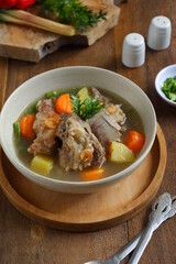 a bowl of beef ribs soup and vegetables