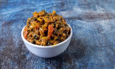 Snali Gravy or Curry in a Bowl Isolated on Bluish Background with Copy Space