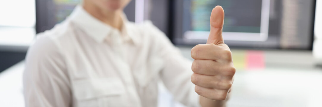 Online stock broker holding thumbs up closeup
