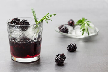 Misted glass with infused blackberries water and ice.