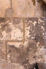 Antique stone wall background with stains and cracks