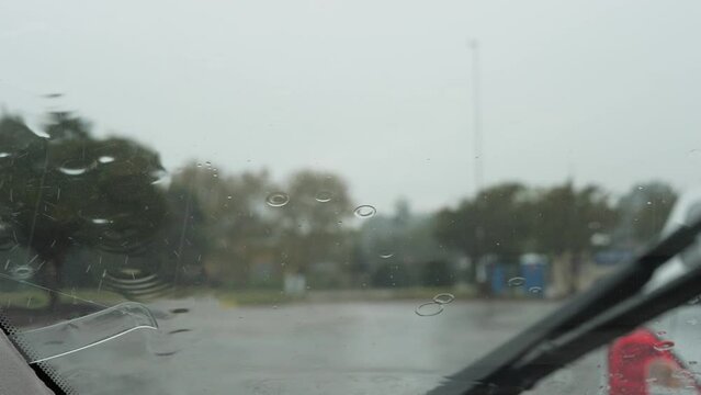 Cinematic windshield wiper wiping rain away in slow motion 4K