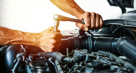 car service concept. engine repairing close up. mechanic hands are repairing car engine