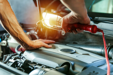 mechanic examines the car engine. checking the health of the car engine. visual inspection of the car engine