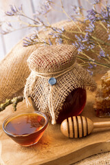 Natural forest bee honey glass jar and bowl, honeycombs pieces and dipper