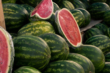 Watermelons are whole and cut in plastic wrap.